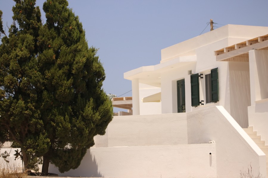 Private yacht sailing past the iconic white cliffs and sea caves of Kleftiko, Milos, on a bespoke island boat tour.